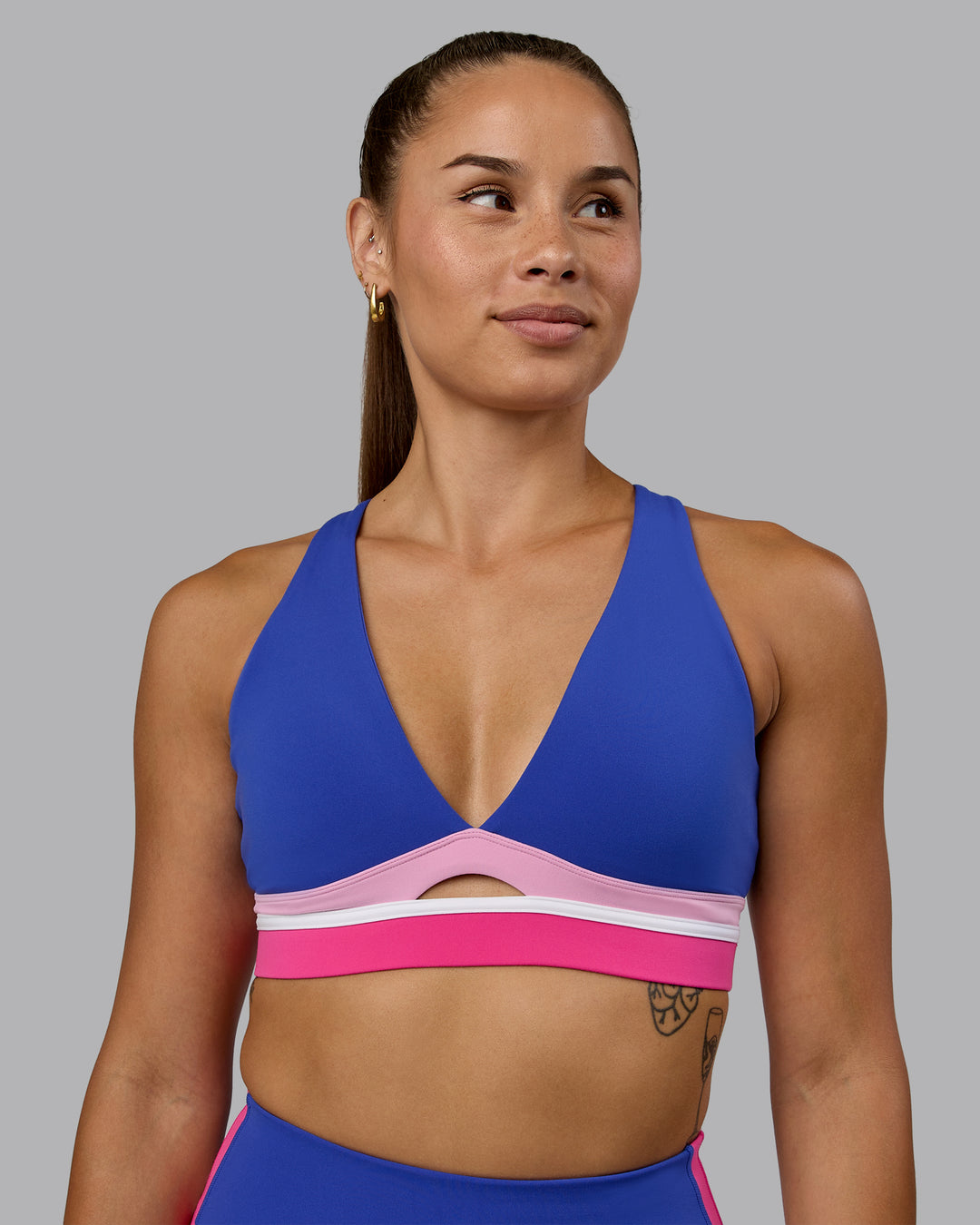 Woman wearing Revitalise Sports Bra - Power Cobalt-Fuchsia Pink