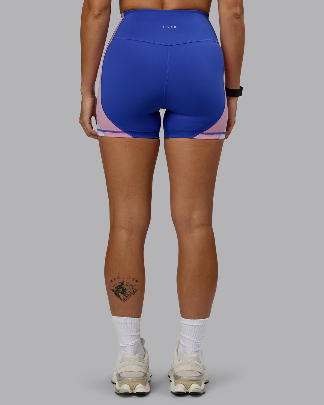 Woman wearing Revitalise Ultra High-Rise 4&quot; Short - Power Cobalt-Fuchsia Pink
