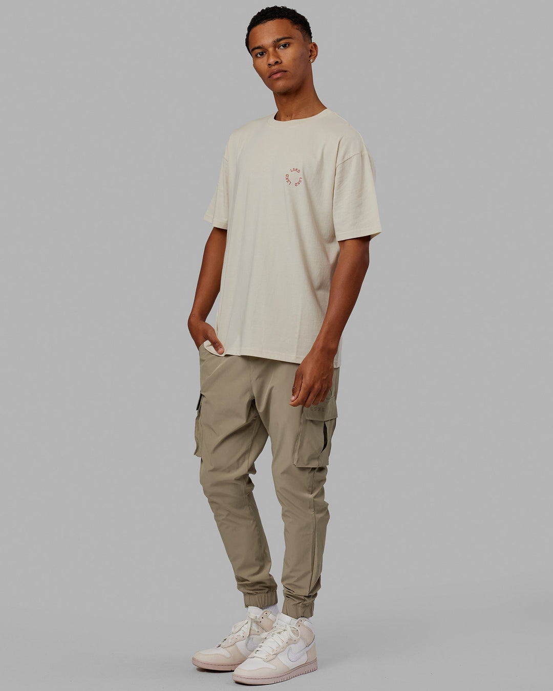 Man wearing Unisex Rotate Tee Oversize - Bone-Mineral Red
