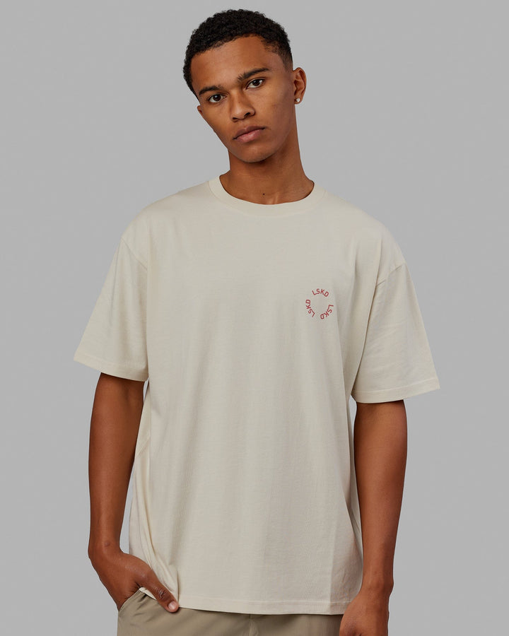 Man wearing Unisex Rotate Tee Oversize - Bone-Mineral Red