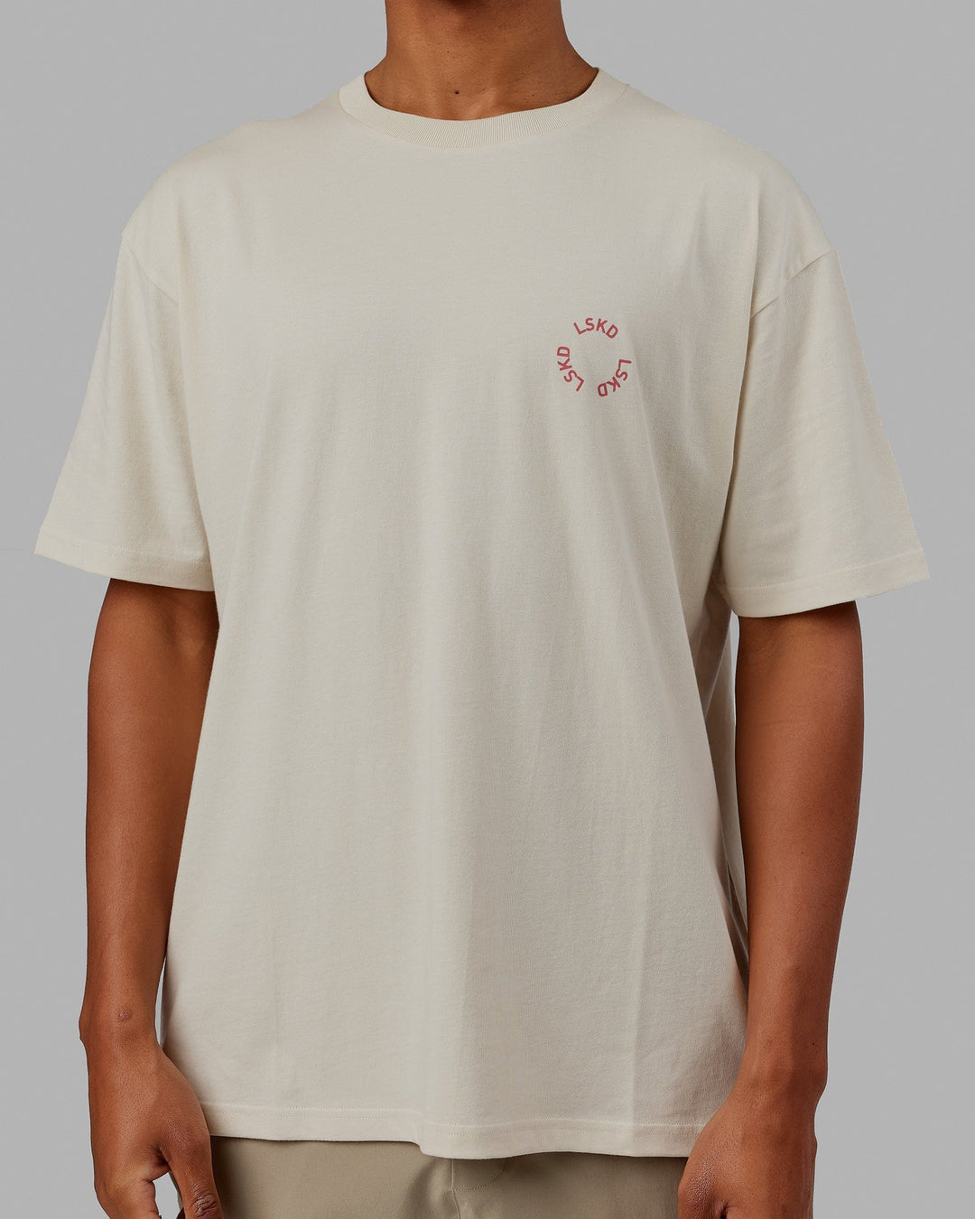 Man wearing Unisex Rotate Tee Oversize - Bone-Mineral Red