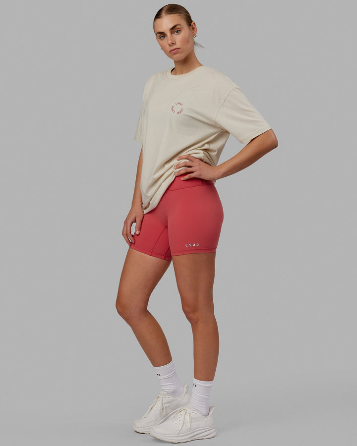 Woman wearing Unisex Rotate Tee Oversize - Bone-Mineral Red