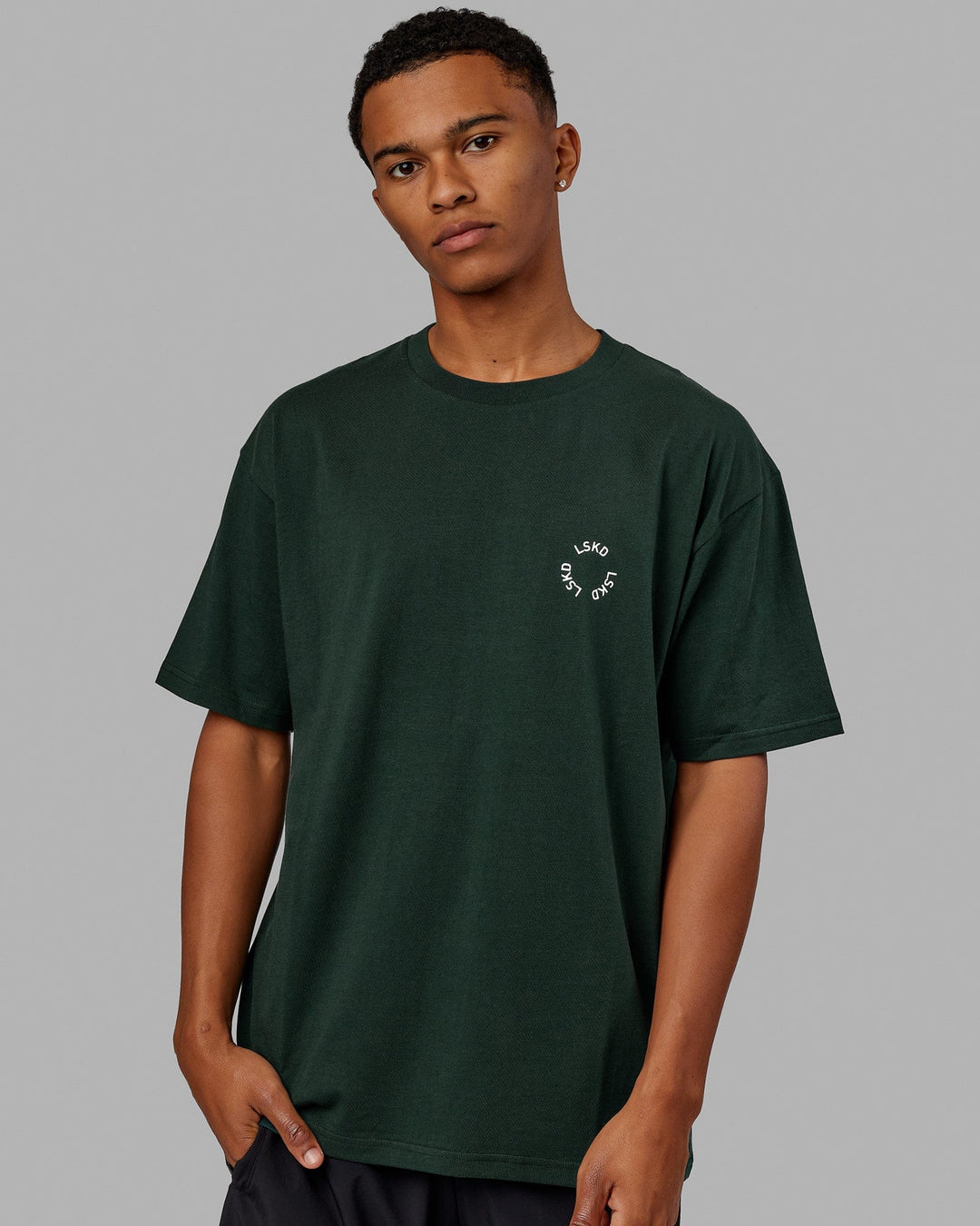 Man wearing Unisex Rotate Tee Oversize - Vital Green-White