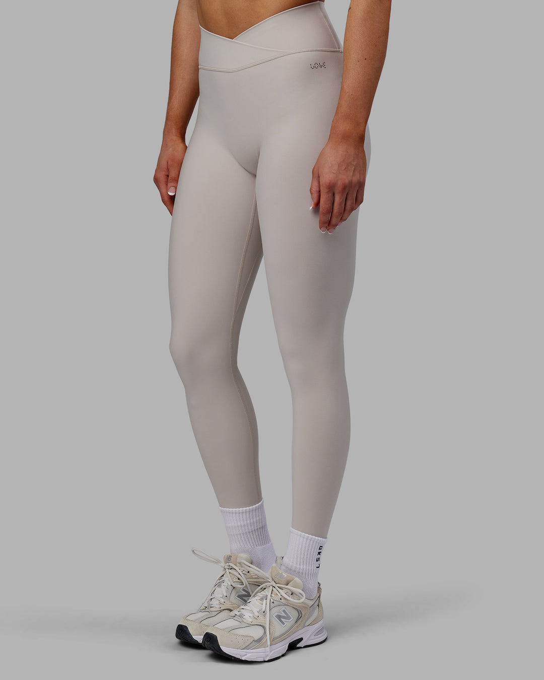 Woman wearing Sara Strike Ultra High-Rise Cross Over Waist Full Length Legging - Shale Beige