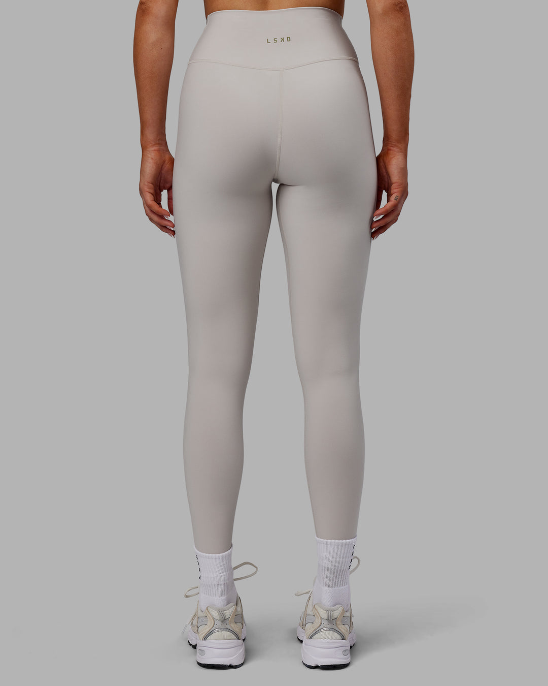 Woman wearing Sara Strike Ultra High-Rise Cross Over Waist Full Length Legging - Shale Beige