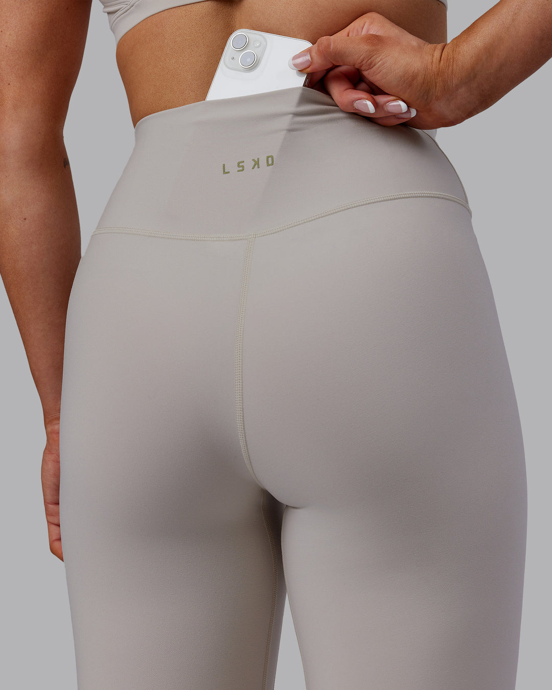 Woman wearing Sara Strike Ultra High-Rise Cross Over Waist Full Length Legging - Shale Beige