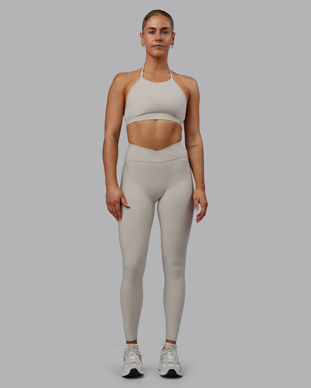Woman wearing Sara Strike Ultra High-Rise Cross Over Waist Full Length Legging - Shale Beige