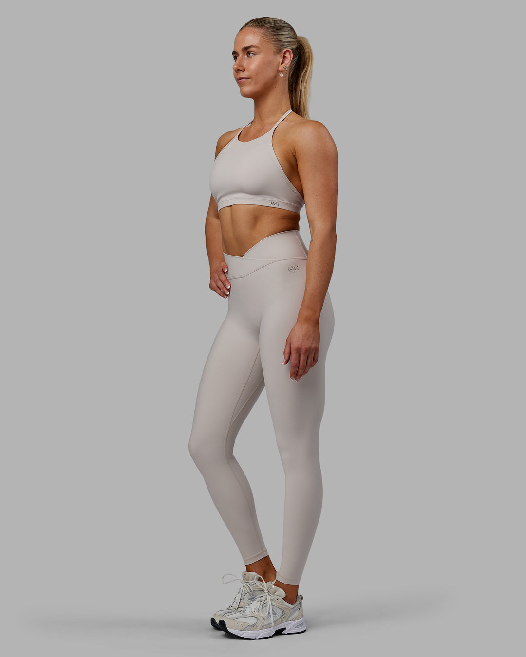Woman wearing Sara Strike Ultra High-Rise Cross Over Waist Full Length Legging - Shale Beige