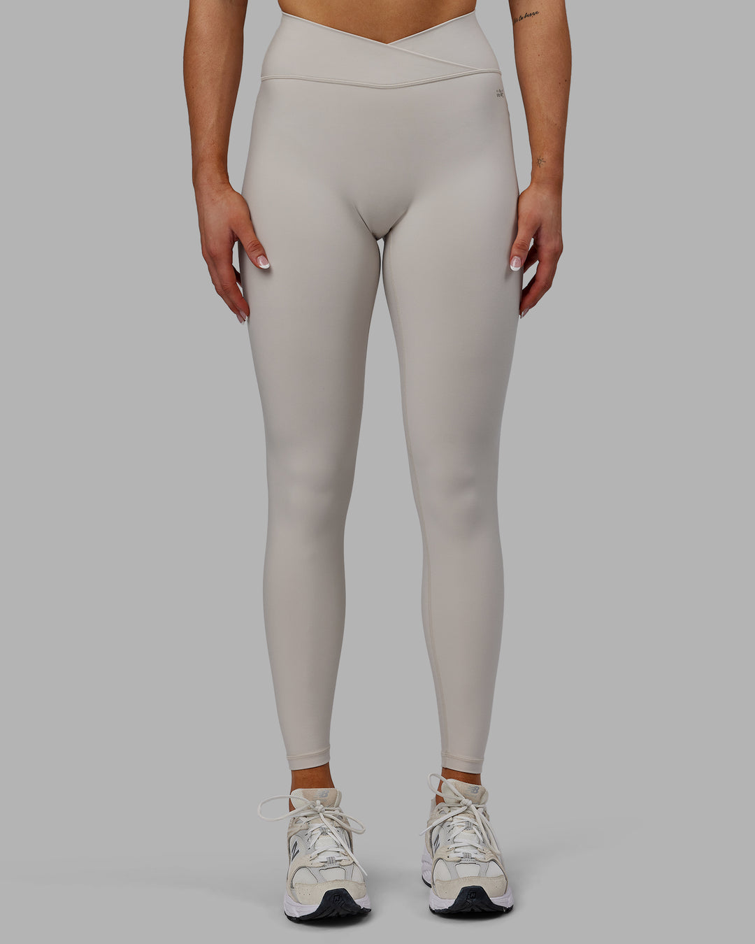 Woman wearing Sara Strike Ultra High-Rise Cross Over Waist Full Length Legging - Shale Beige