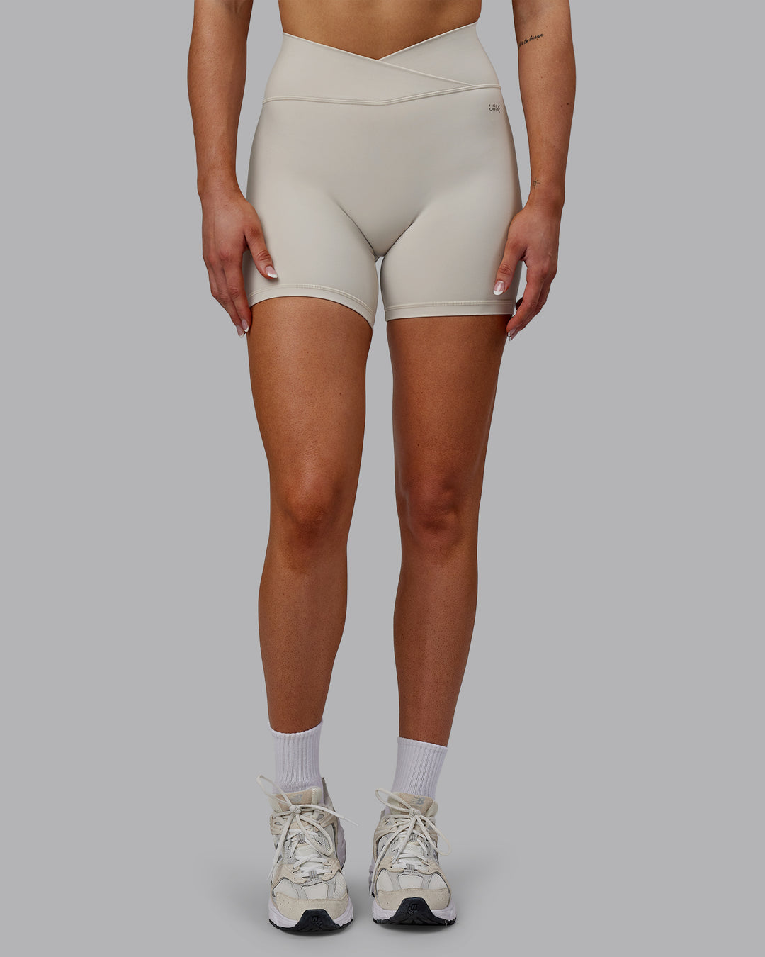 Woman wearing Sara Strike Ultra High-Rise Cross Over Waist 6&quot; Short - Shale Beige
