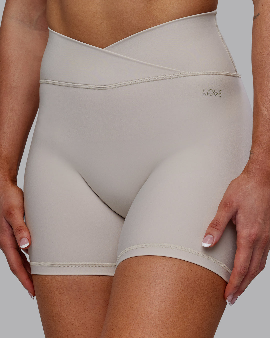Woman wearing Sara Strike Ultra High-Rise Cross Over Waist 6&quot; Short - Shale Beige