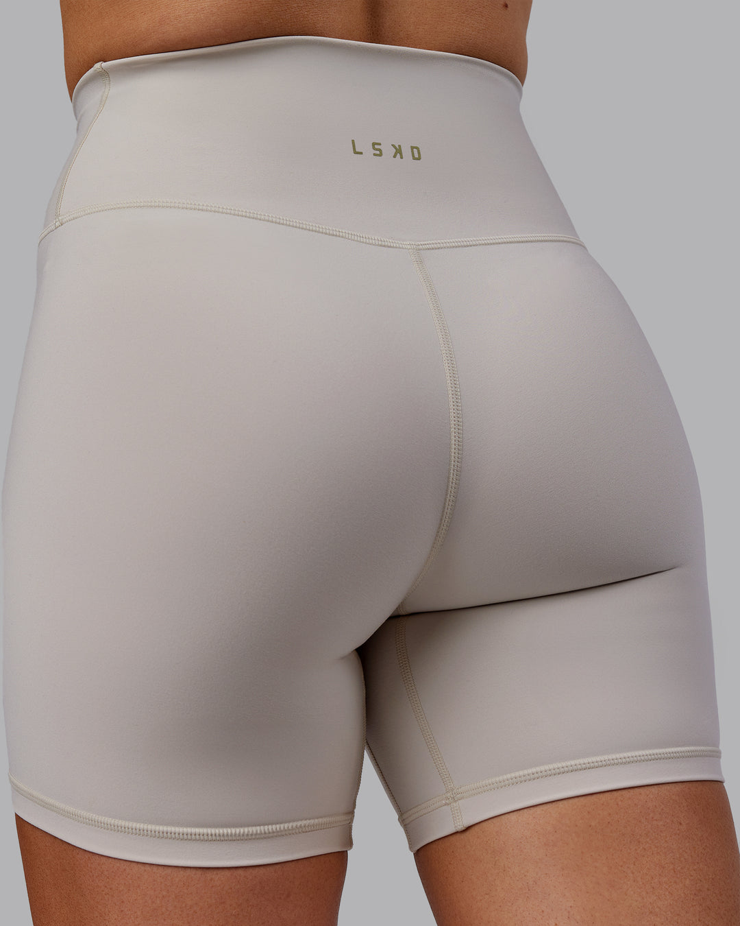 Woman wearing Sara Strike Ultra High-Rise Cross Over Waist 6&quot; Short - Shale Beige