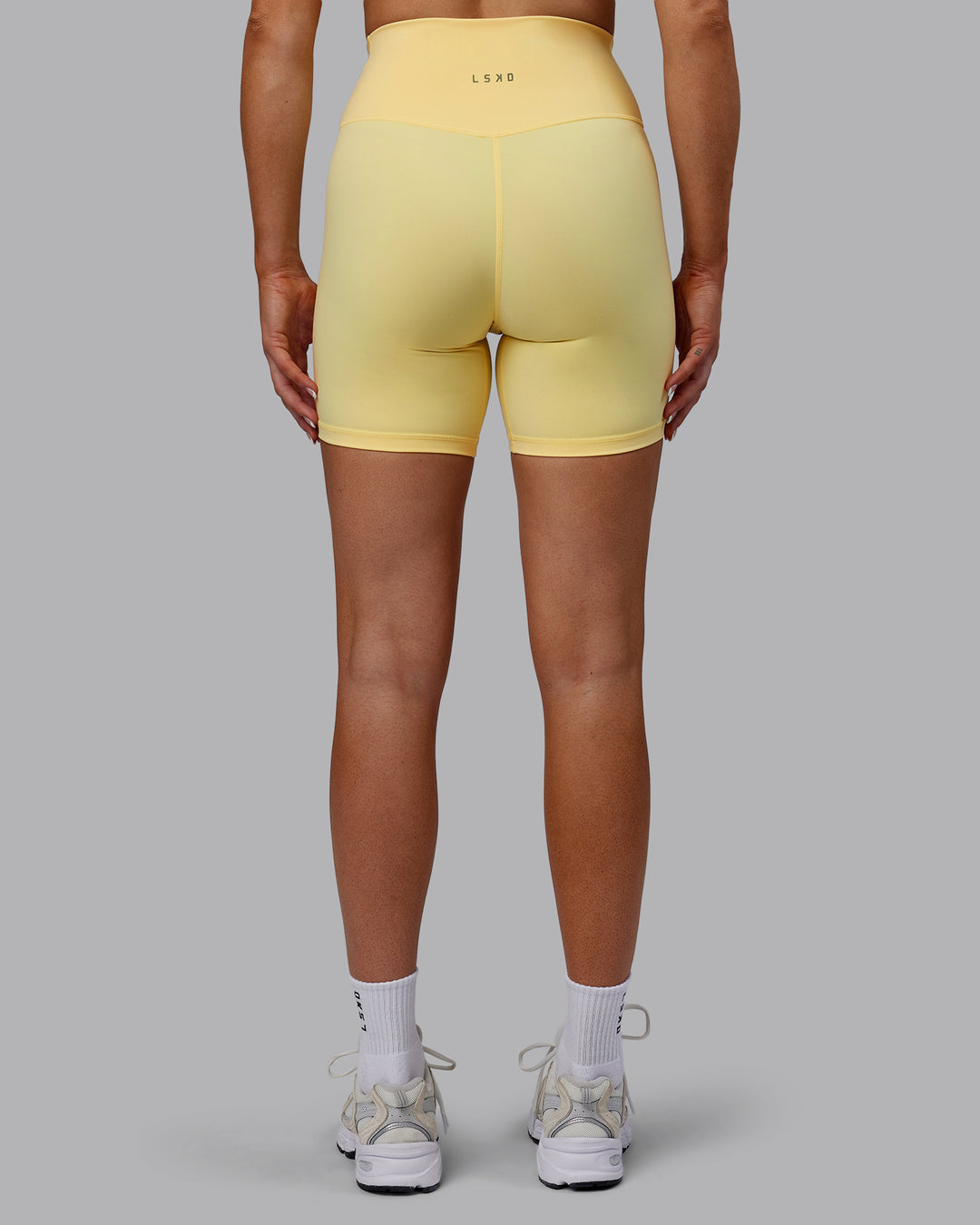 Woman wearing Sara Strike Ultra High-Rise Cross Over Waist 6&quot; Short - Sunflower