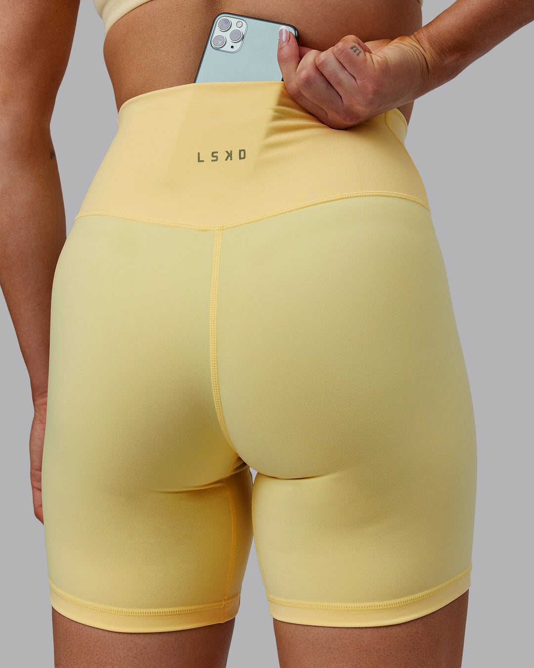 Woman wearing Sara Strike Ultra High-Rise Cross Over Waist 6&quot; Short - Sunflower