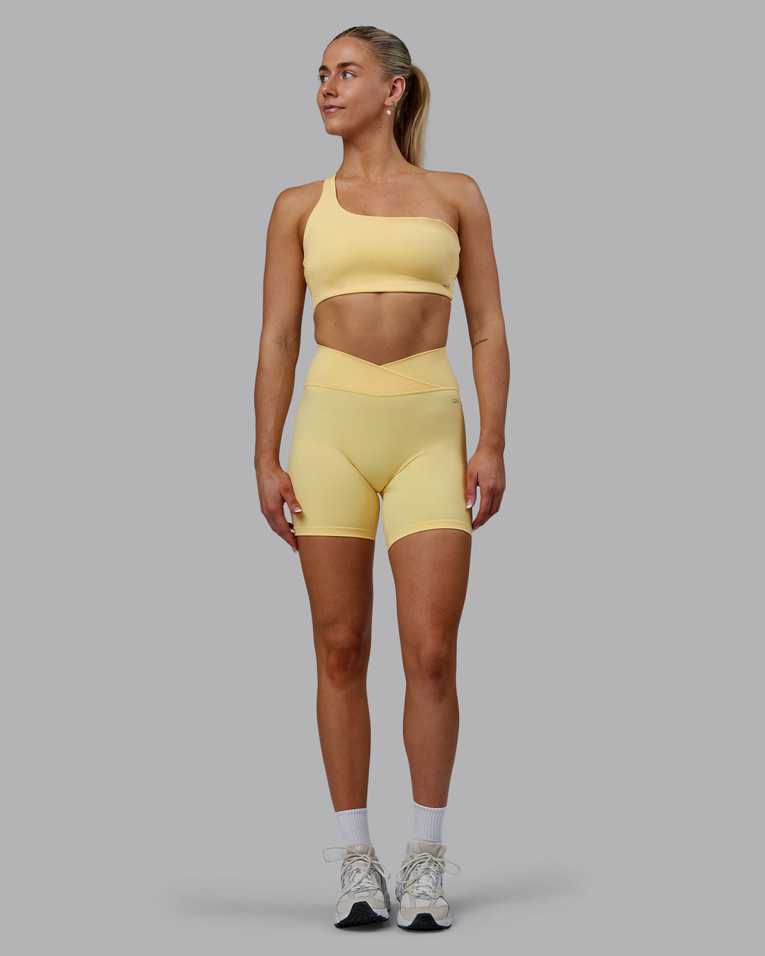 Woman wearing Sara Strike Ultra High-Rise Cross Over Waist 6&quot; Short - Sunflower