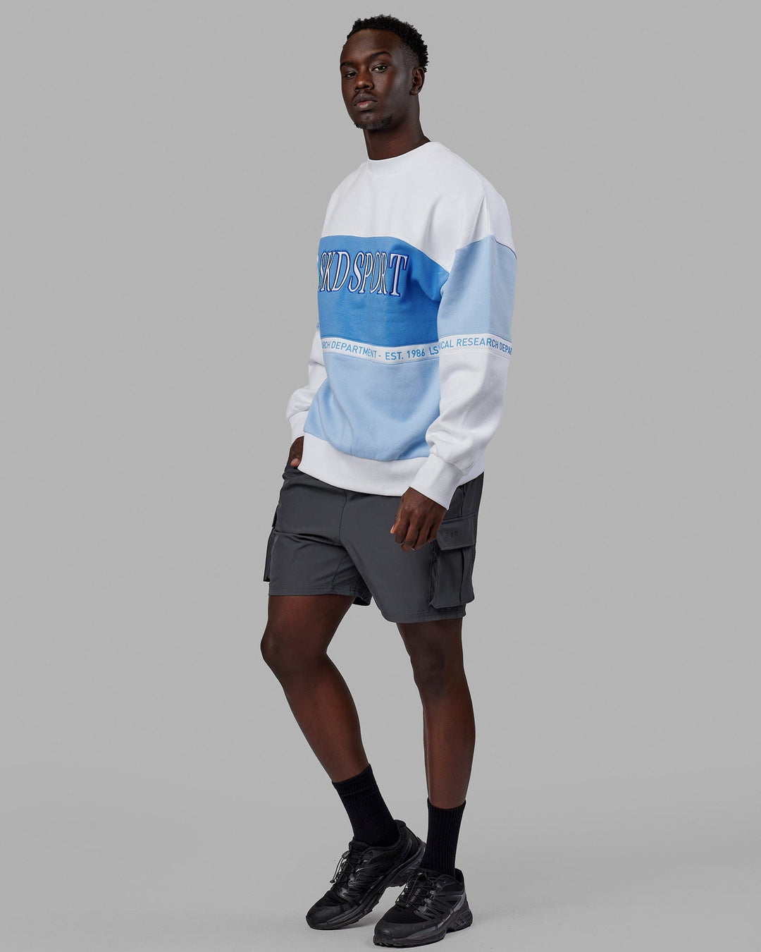 Man wearing Unisex Sportif Sweater Oversize - Windsurfer-Azure Blue