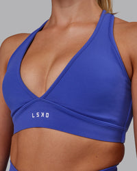 Woman wearing Stamina Sports Bra - Power Cobalt | Set:true | Angle:closeup | Model:Hannah | Size:S