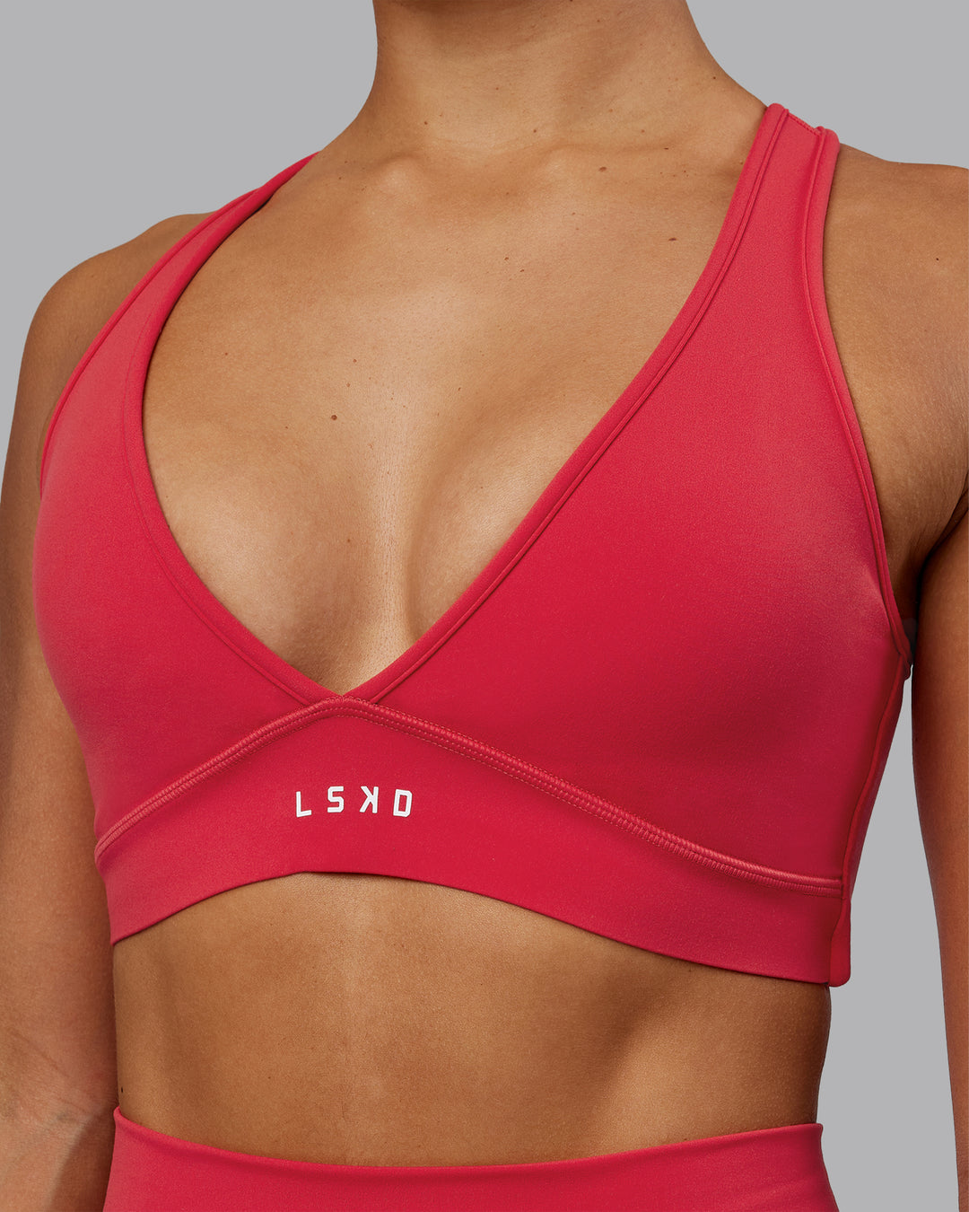 Woman wearing Stamina Sports Bra in Scarlet | Size:S