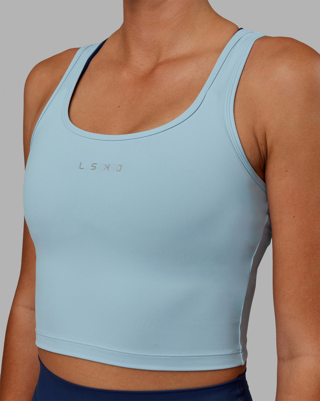 Woman wearing Staple Active Cropped Tank - Glacial Blue