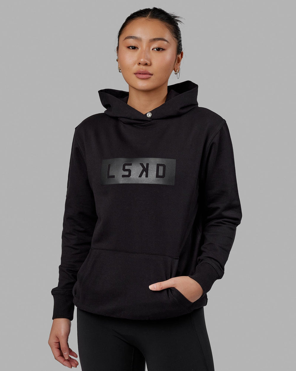 Woman wearing Unisex Strength FLXFLeece Hoodie - Black-Black