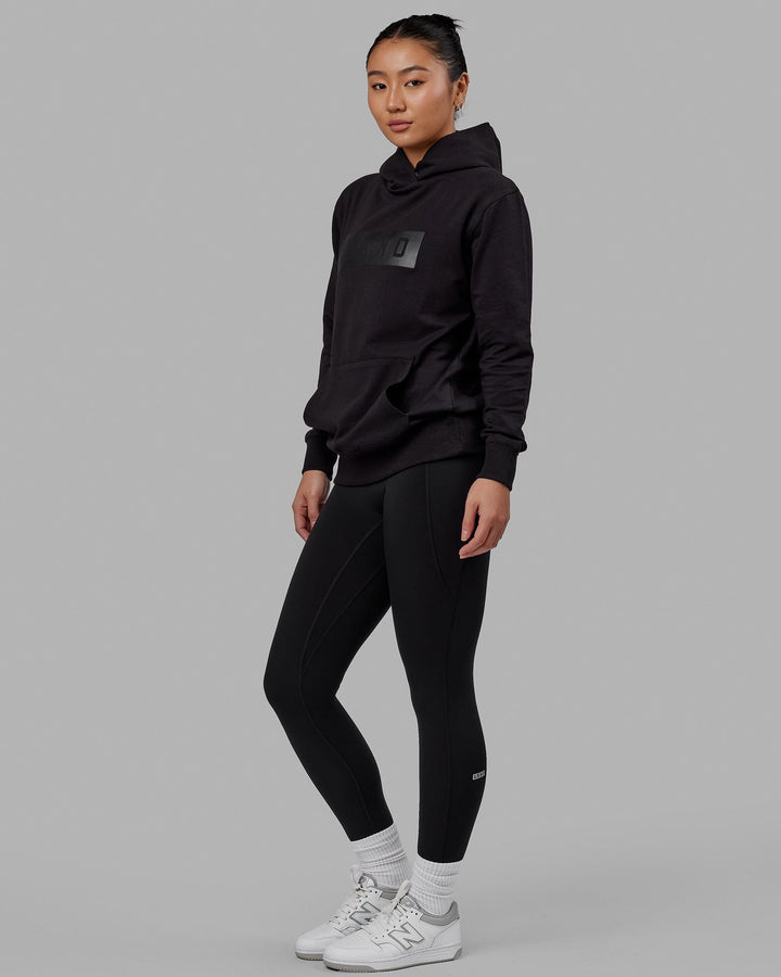 Woman wearing Unisex Strength FLXFLeece Hoodie - Black-Black