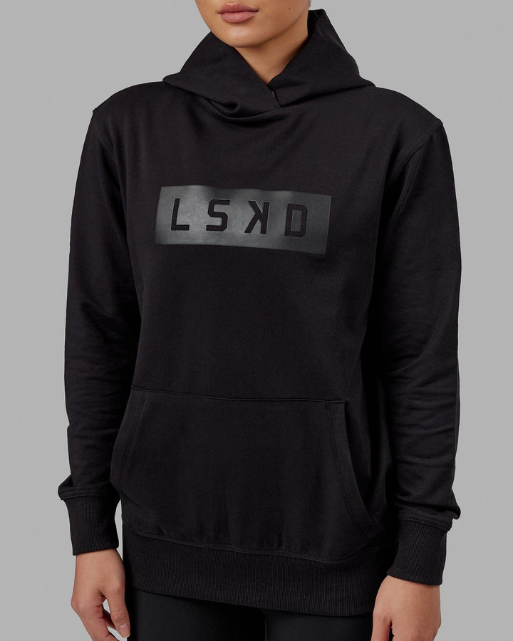 Woman wearing Unisex Strength FLXFLeece Hoodie - Black-Black