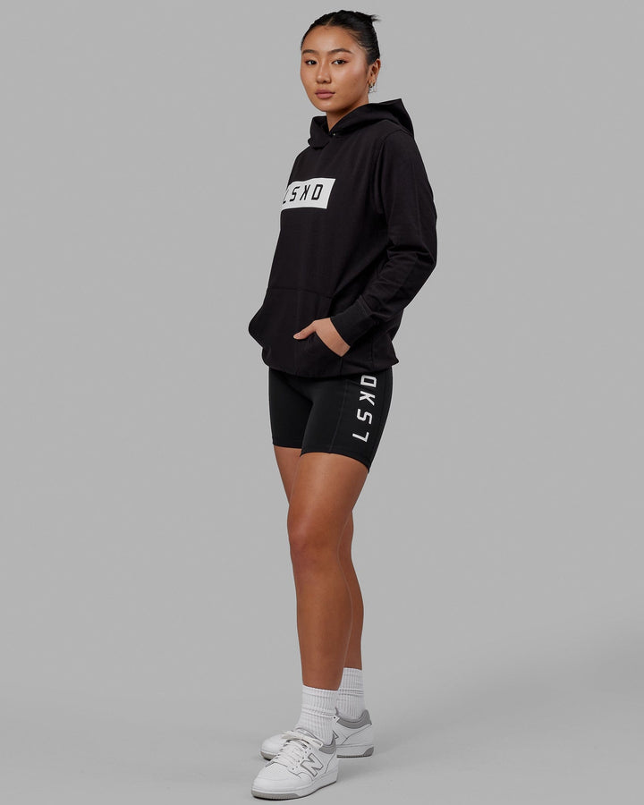 Woman wearing Unisex Strength FLXFLeece Hoodie - Black-White