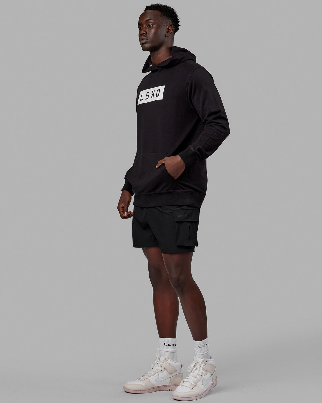 Man wearing Unisex Strength FLXFLeece Hoodie - Black-White