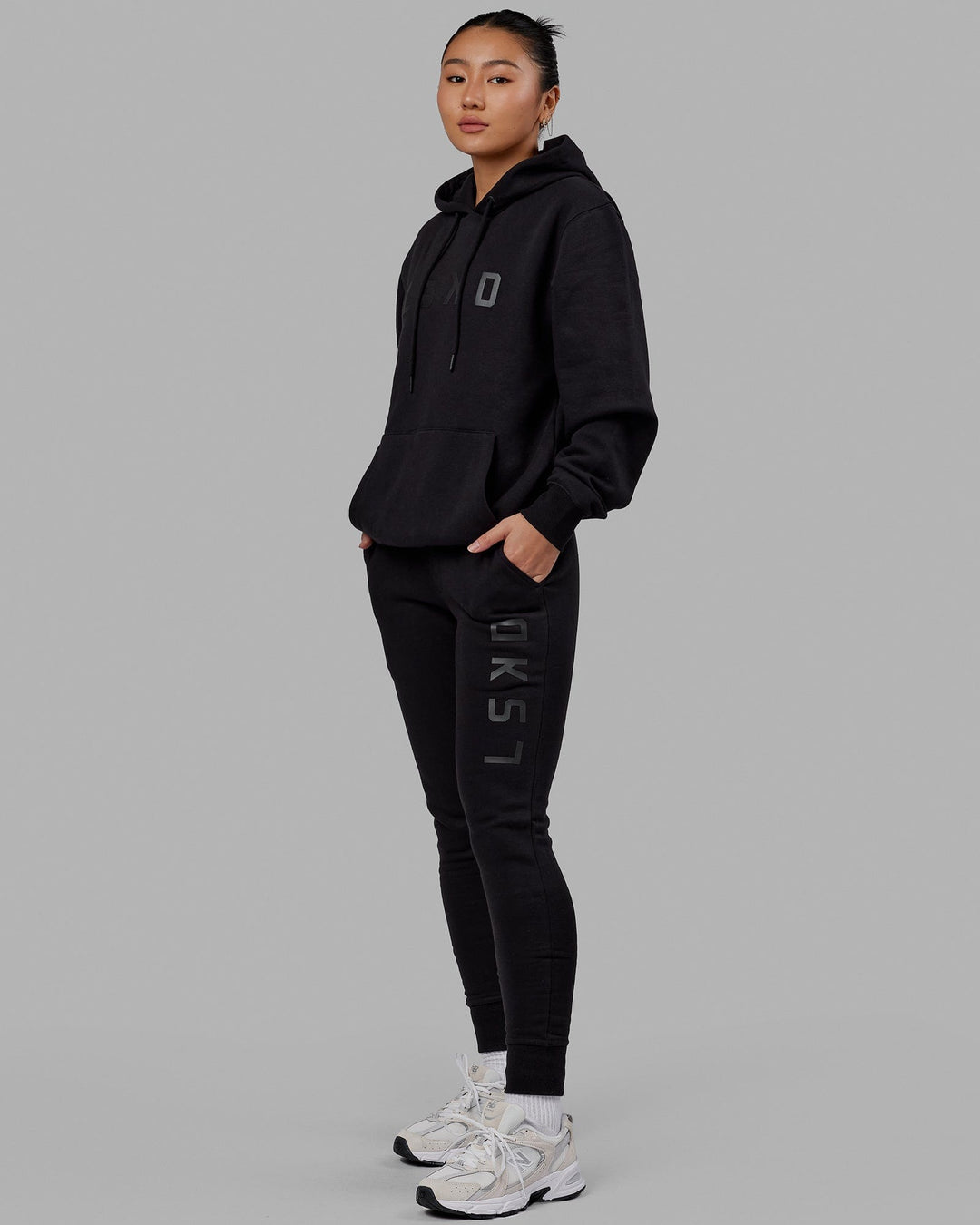 Woman wearing Unisex Structure Hoodie - Black-Black
