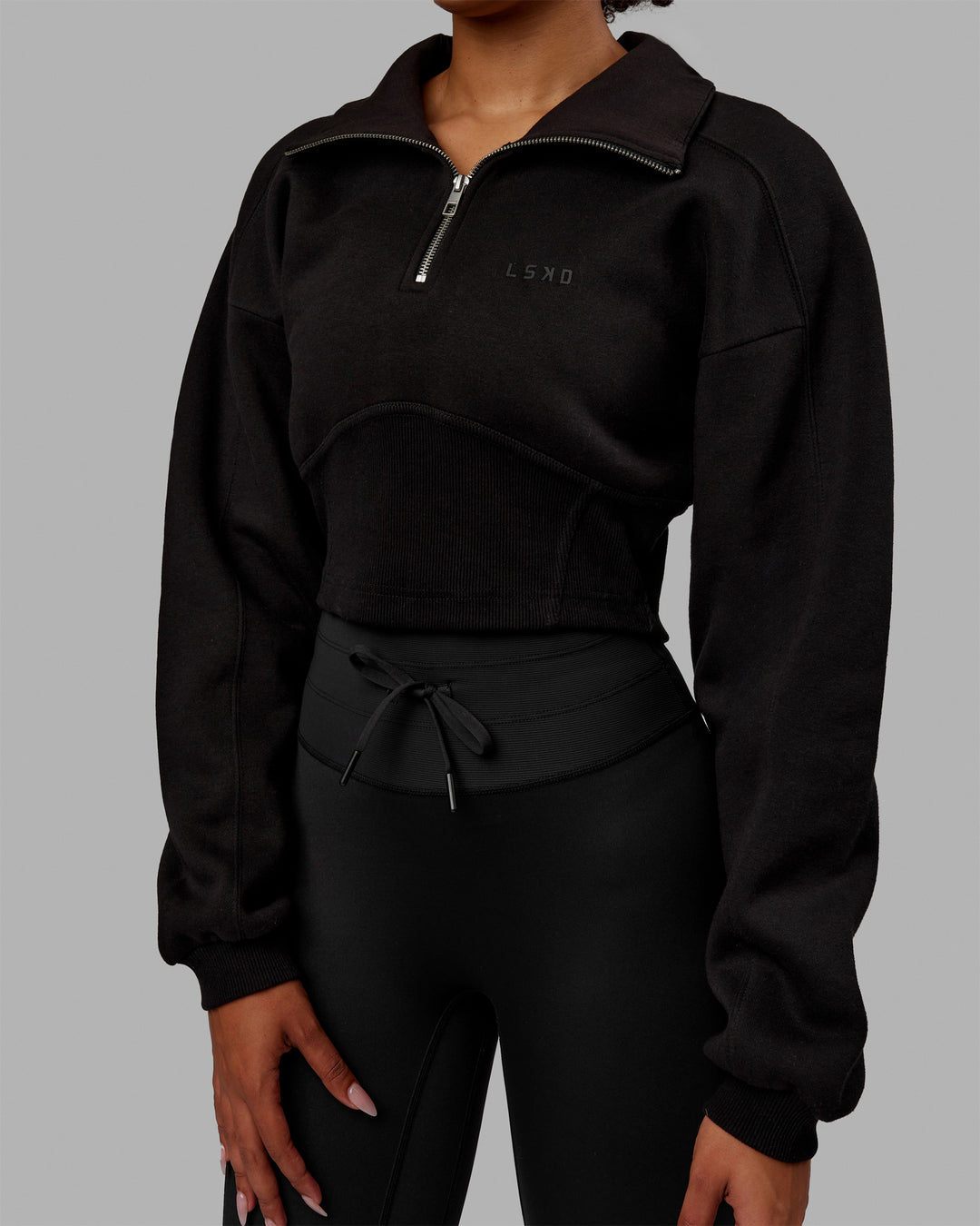 Woman wearing Thrive Corset 1/4 Zip Sweater - Black