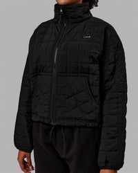 Woman wearing Thrive Packable Jacket - Black