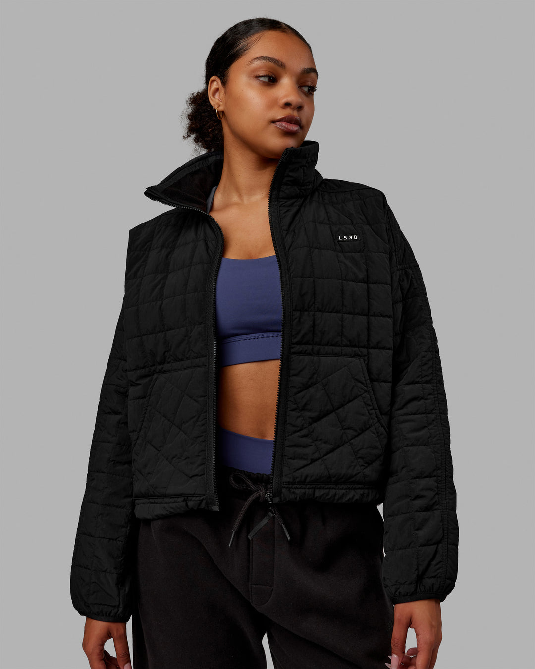 Woman wearing Thrive Packable Jacket - Black