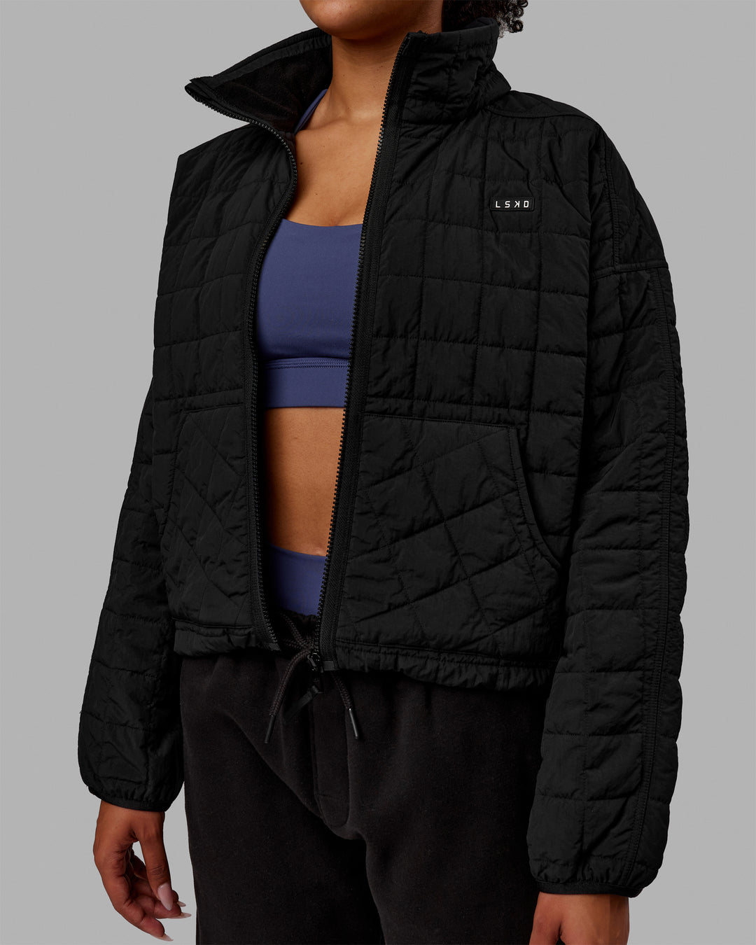 Woman wearing Thrive Packable Jacket - Black