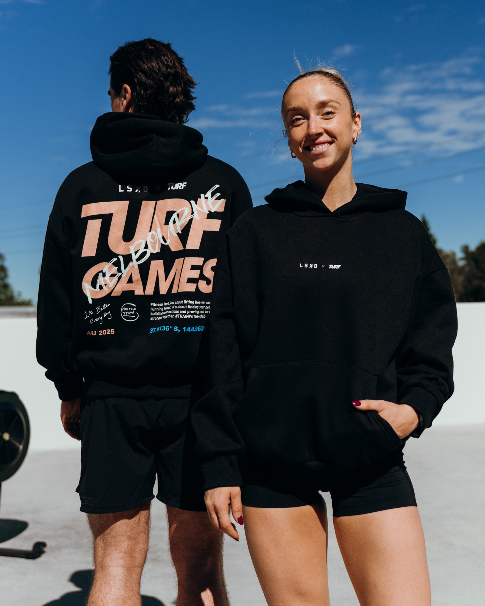 Duo wearing Turf Games Melbourne Event Oversized Hoodie - Black | Model:Both | Size:Duo