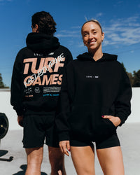 Duo wearing Turf Games Melbourne Event Oversized Hoodie - Black | Model:Both | Size:Duo