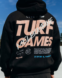 Man wearing Turf Games Melbourne Event Oversized Hoodie - Black | Model:Adam | Size:L