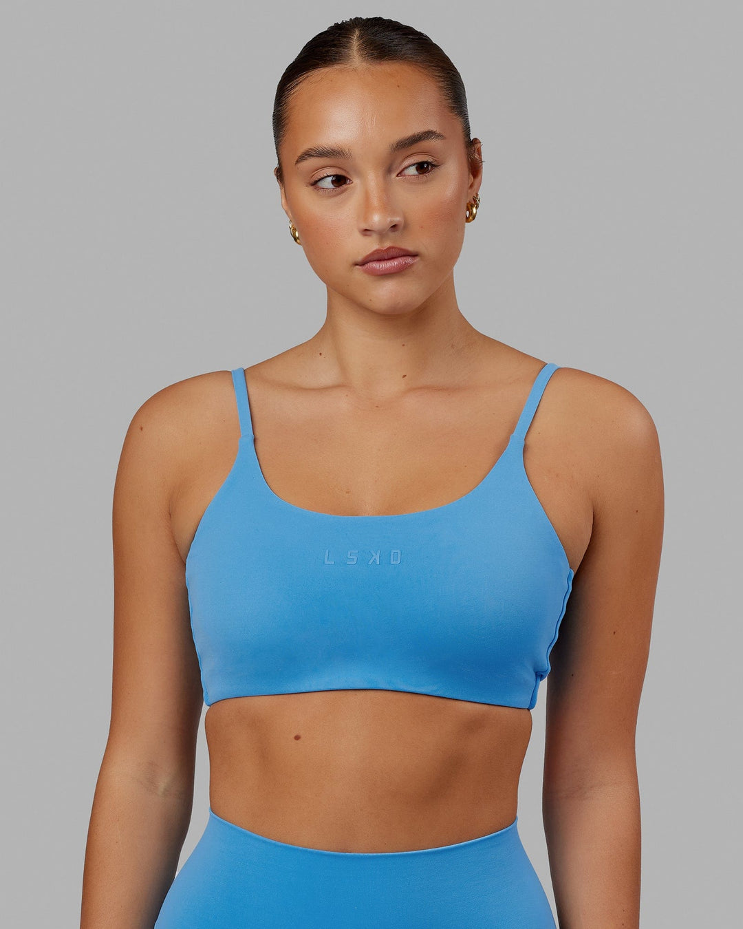 Woman wearing Twist Sports Bra - Azure Blue