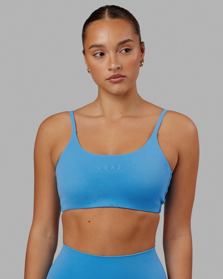 Woman wearing Twist Sports Bra - Azure Blue