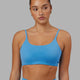 Woman wearing Twist Sports Bra - Azure Blue