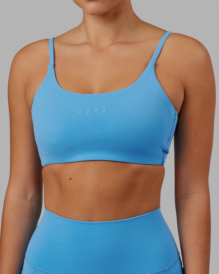 Woman wearing Twist Sports Bra - Azure Blue