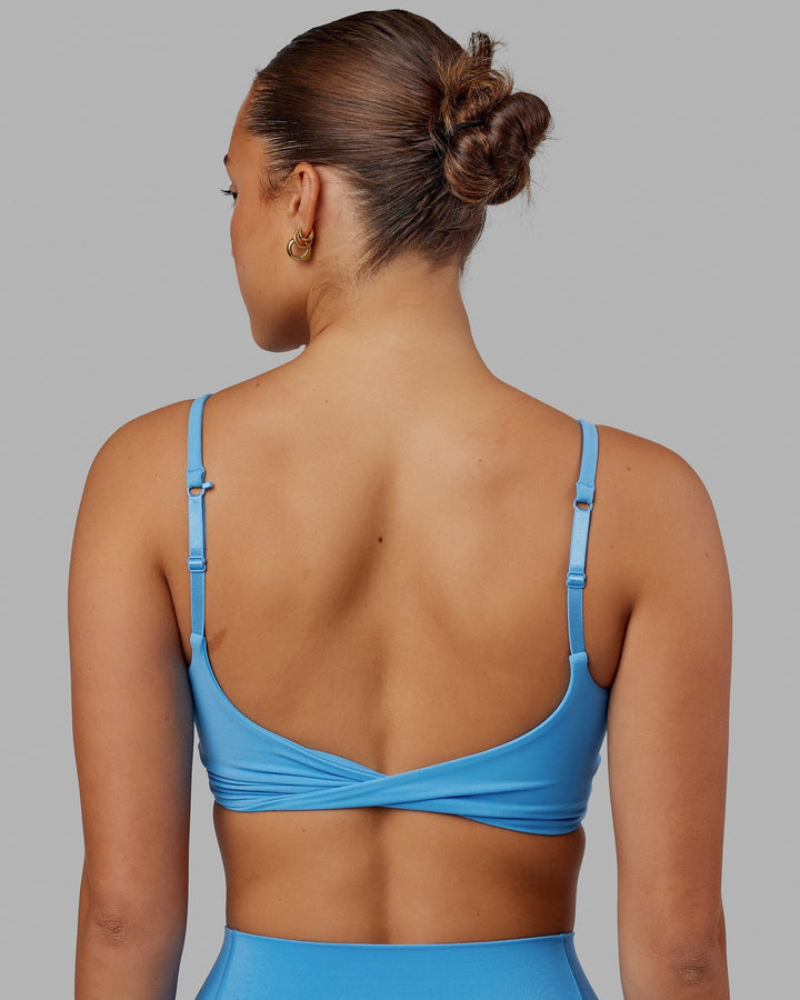 Woman wearing Twist Sports Bra - Azure Blue