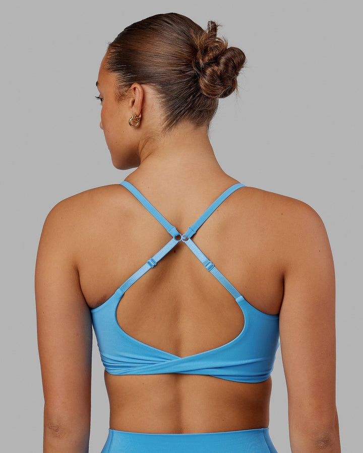 Woman wearing Twist Sports Bra - Azure Blue
