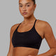 Woman wearing Twist Sports Bra - Black