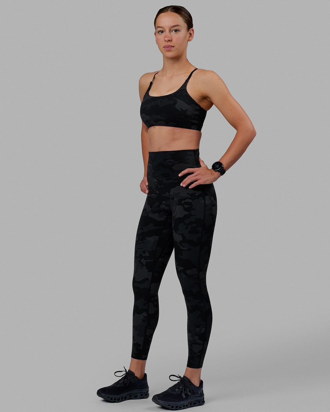 Woman wearing Twist Sports Bra - Black Camo