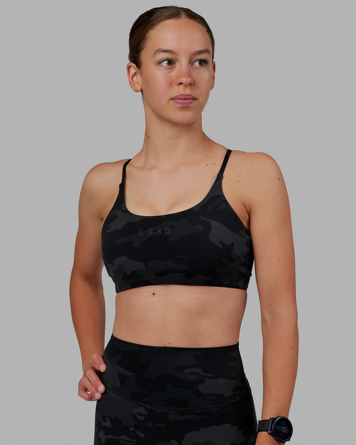 Woman wearing Twist Sports Bra - Black Camo