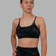 Woman wearing Twist Sports Bra - Black Camo