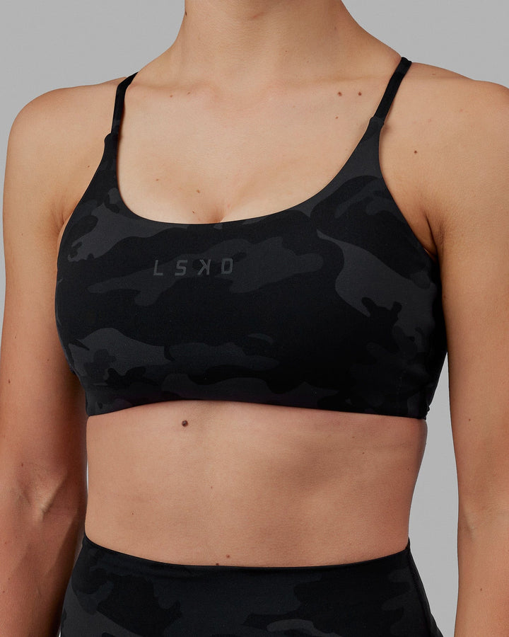 Woman wearing Twist Sports Bra - Black Camo