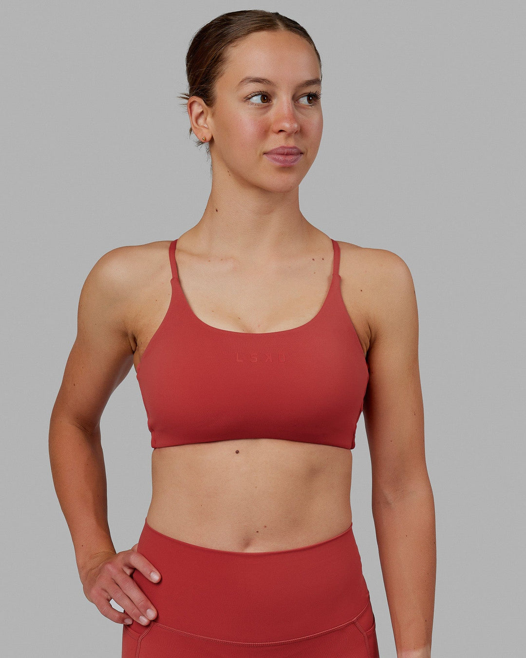 Woman wearing Twist Sports Bra - Cardinal