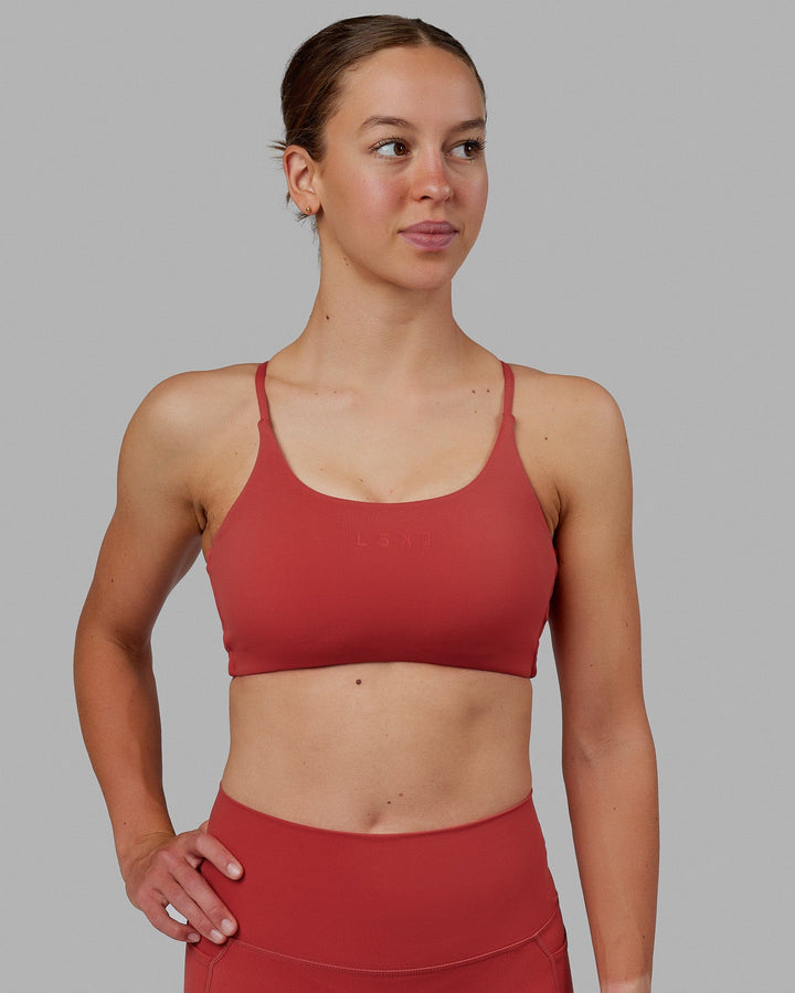 Woman wearing Twist Sports Bra - Cardinal