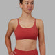 Woman wearing Twist Sports Bra - Cardinal